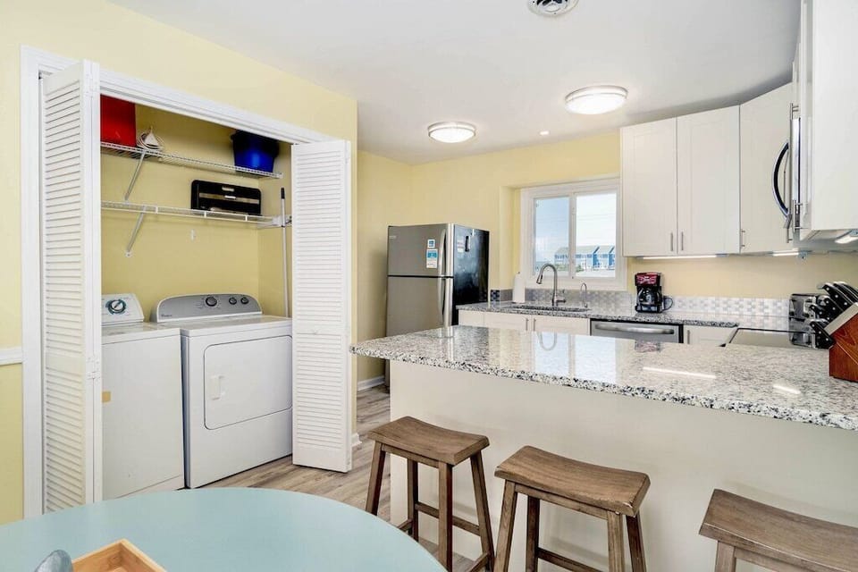 Laundry space with full size Washer/Dryer, grill accessories, and more