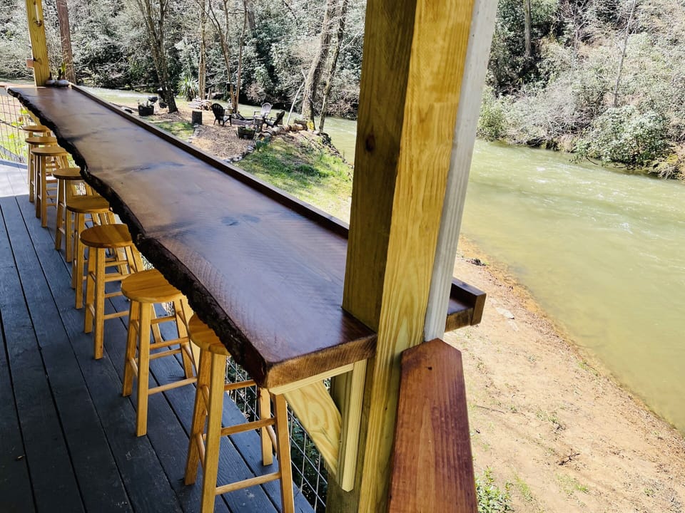 Porch overlooking trophy trout stream & fire pit with 18ft bar w/ seating area 