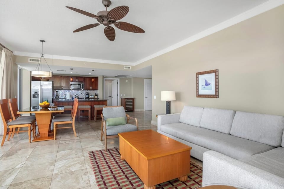 Spacious island retreat with modern kitchen, cozy seating, tropical charm.