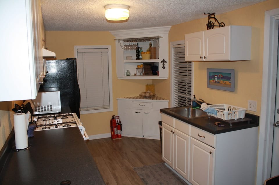 Full kitchen, microwave, fridge, toaster, coffee maker, blender, plates etc