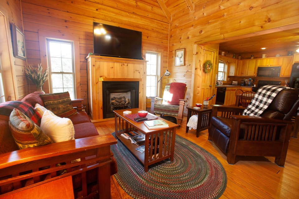 The den offers a gas fireplace and seating for 5 around the TV.