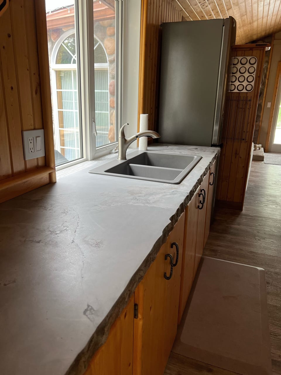 Kitchen - concrete counters, fridge and stove.