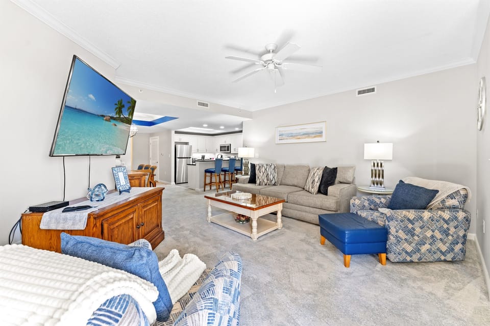 Comfortable Living Room with large TV and balcony access