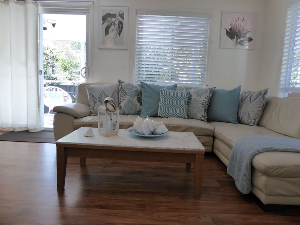Lounge  room with access to deck with seating for 8 and BBQ