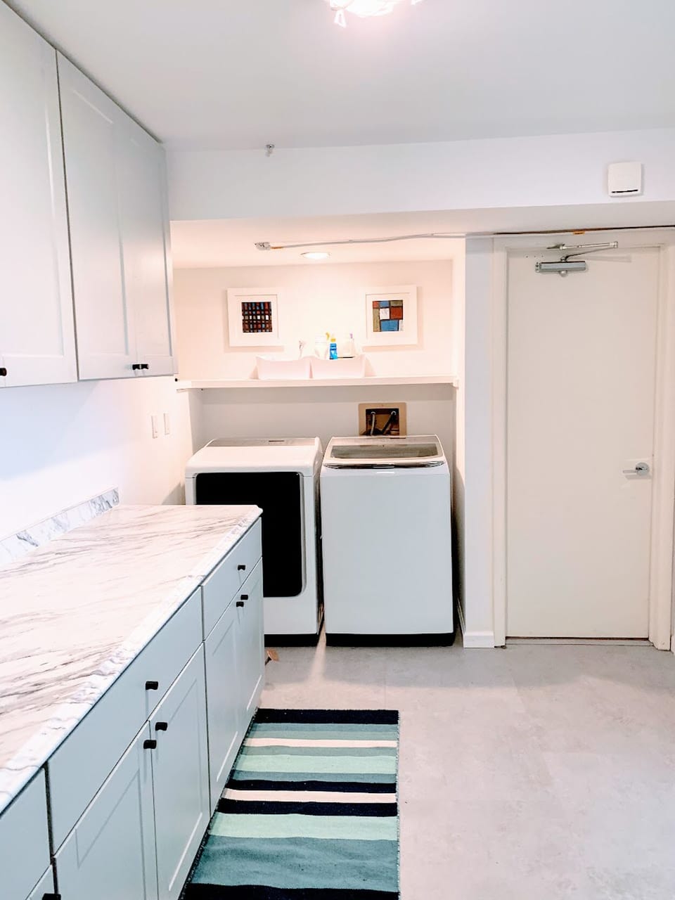Laundry room with cabinets full of towels and linens