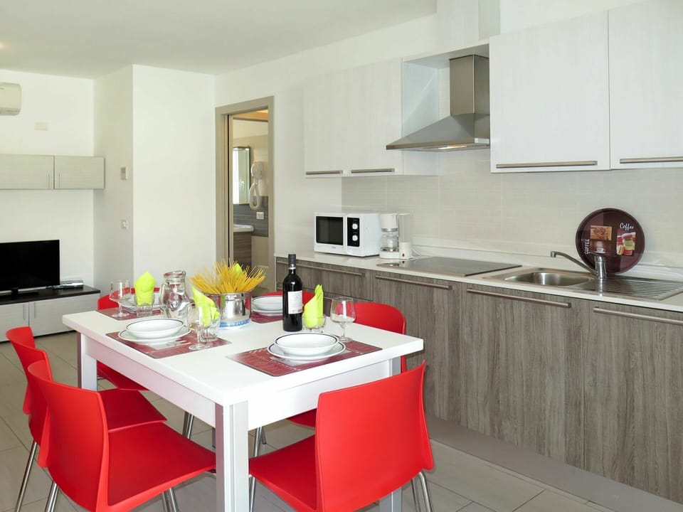 Countertop, Room, Furniture, Kitchen, Property, Interior Design, Cabinetry, Building, Yellow, Floor