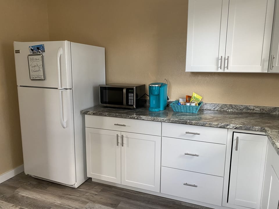 Kitchen with fridge, microwave and Keurig 