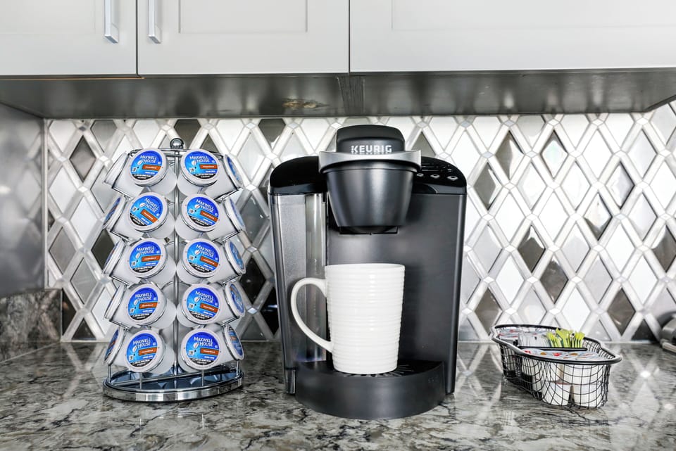 Keurig with complimentary (limited) supply of K-cups, sweetener, and creamer. Yum! Stocked in Every Home.