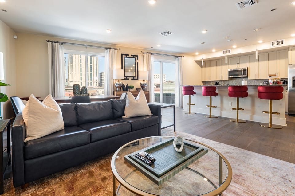 Open concept living, kitchen, and dining area with ample comfortable seating options for you and your guests. 65” Samsung Smart 4K TV that allows for streaming from your favorite apps, along with the DIRECTV Entertainment. Lounge on the sofa and cozy chairs after an activity filled day in NOLA! Dining table with seating for four and bar dining with seating for four. All the natural light too!