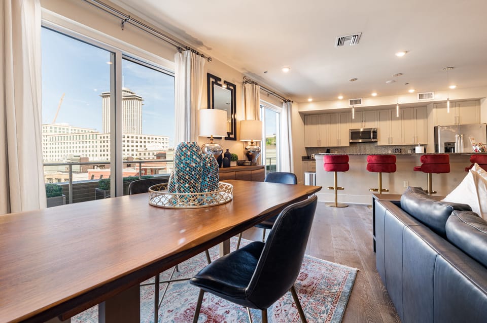 Open concept living, kitchen, and dining area with ample comfortable seating options for you and your guests. 65” Samsung Smart 4K TV that allows for streaming from your favorite apps, along with the DIRECTV Entertainment. Lounge on the sofa and cozy chairs after an activity filled day in NOLA! Dining table with seating for four and bar dining with seating for four. All the natural light too!