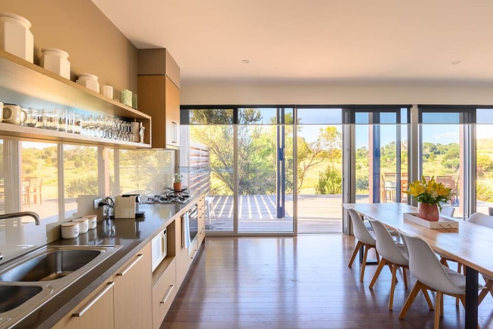 [Kitchen] Modern fully equipped kitchen with cooking appliances, microwave, pots, pans and plenty of cooking utensils for the times you just want to stay in.