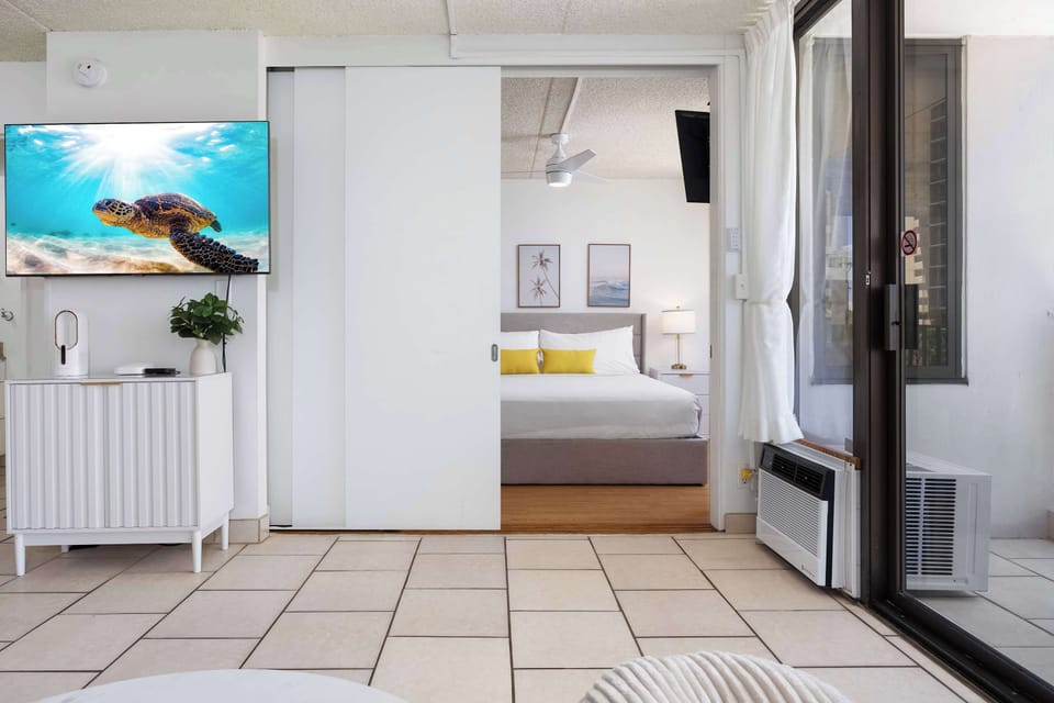 The bedroom is separated from the living area by a sliding door.