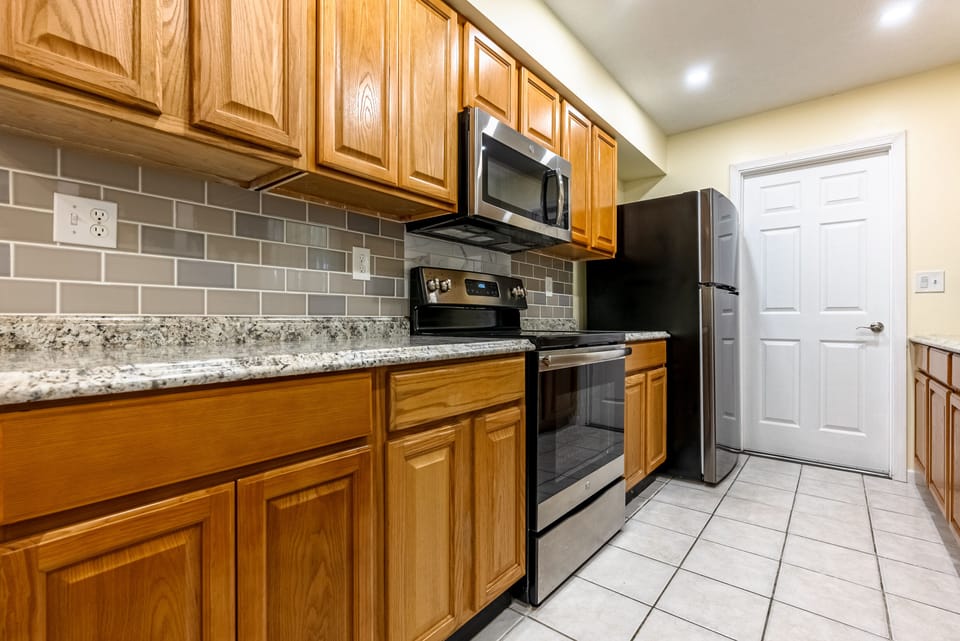 Door to garage which leads to patio with grill.