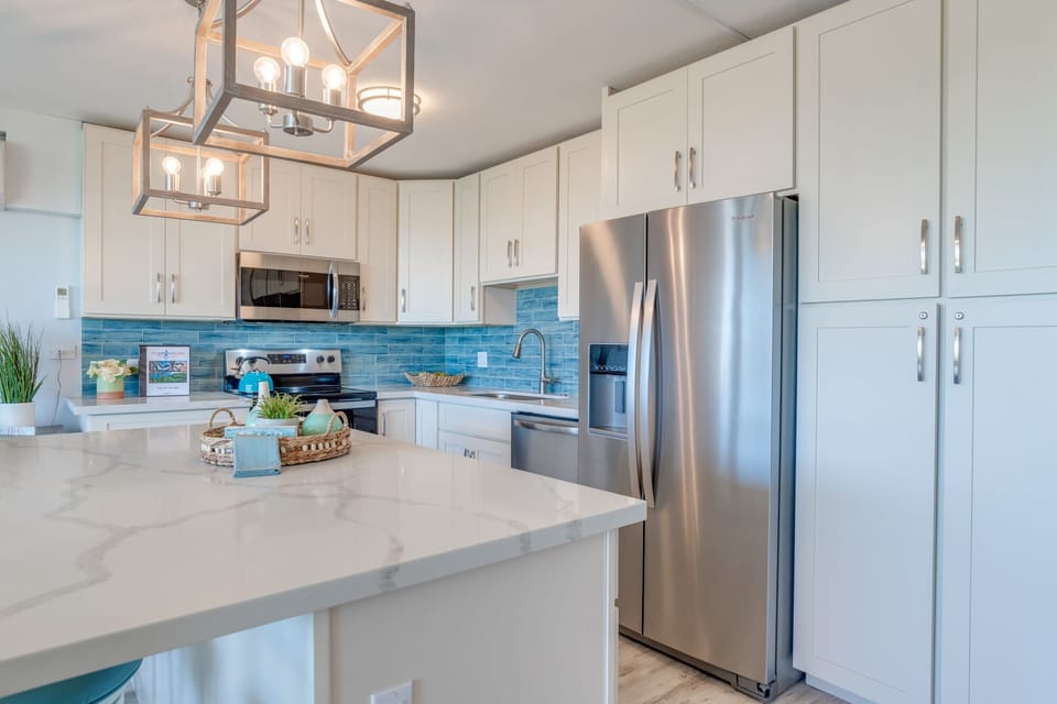 Well-equipped kitchen with new stainless steel appliances.