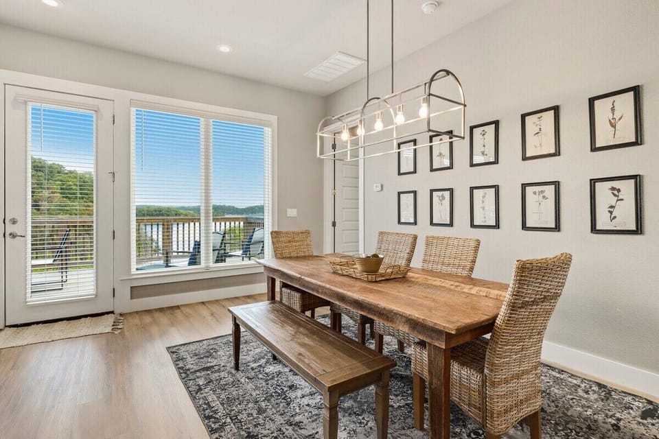 The farmhouse dining table features views of the lake and comfortable seating.