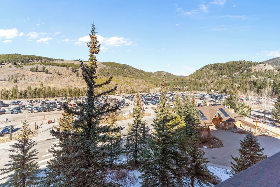Panoramic mountain valley setting with convenient parking and forested hillsides creating a peaceful alpine atmosphere.