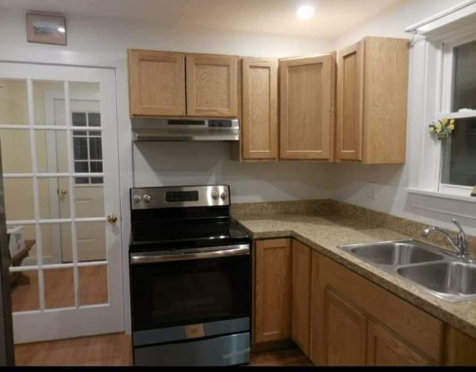 picture of foyer and stove and sink also leading go large deck