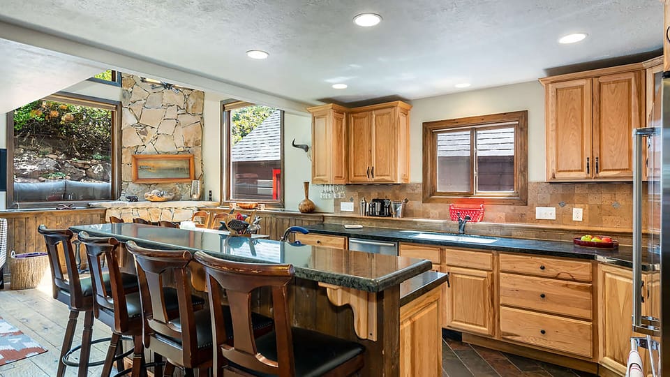 Kitchen features and island with countertop seating and modern appliances.