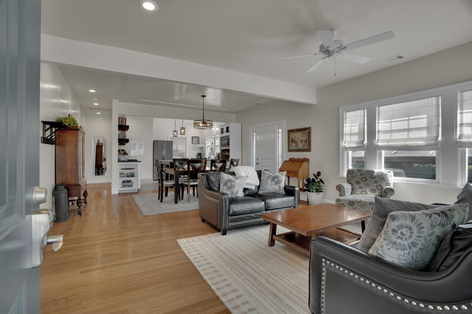 Well lit living room with plenty of seating available.