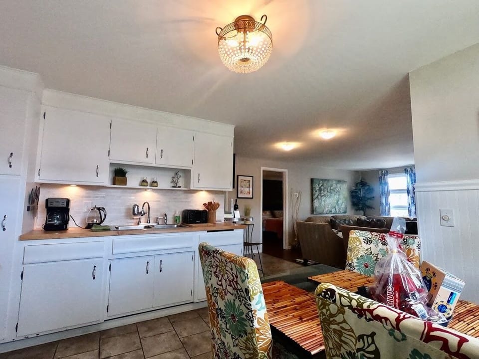 Kitchen is stocked: coffee maker, kettle, toaster, fridge, stove, and microwave.