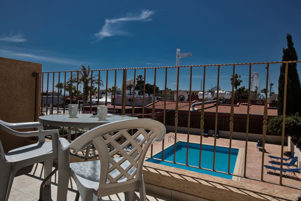 Balcony with seating area overlooking the pool area