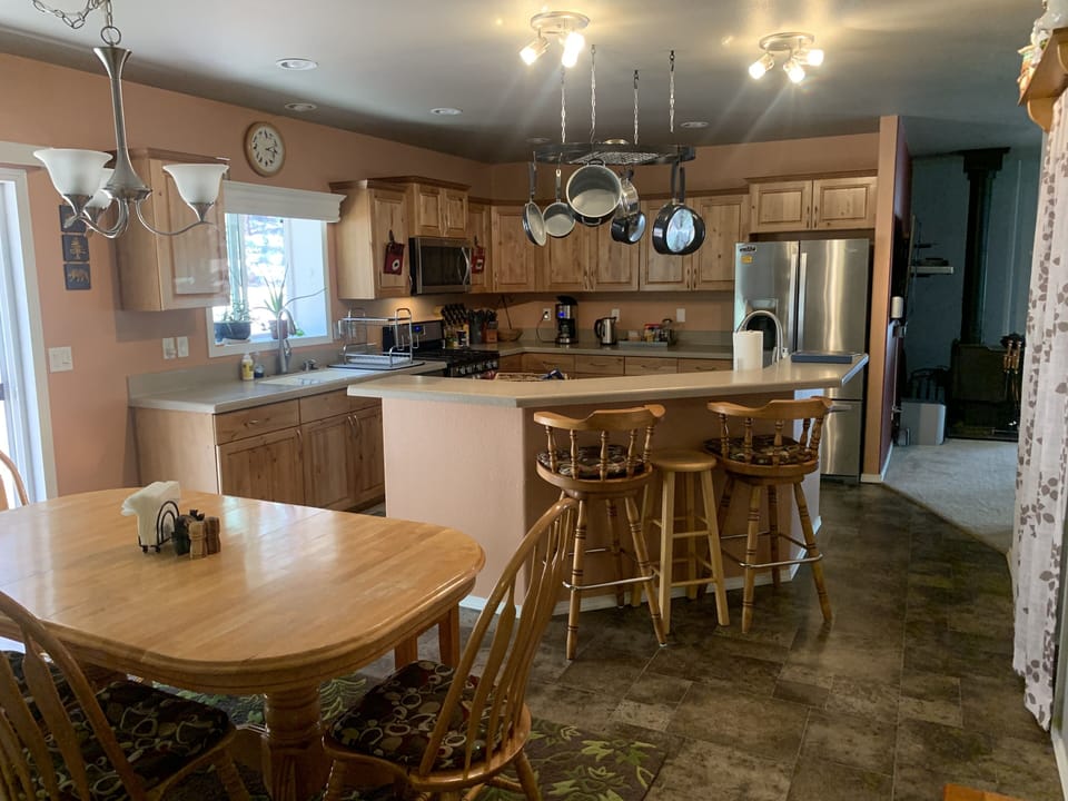 Large kitchen with island bar and dining room. Seating for 10+
