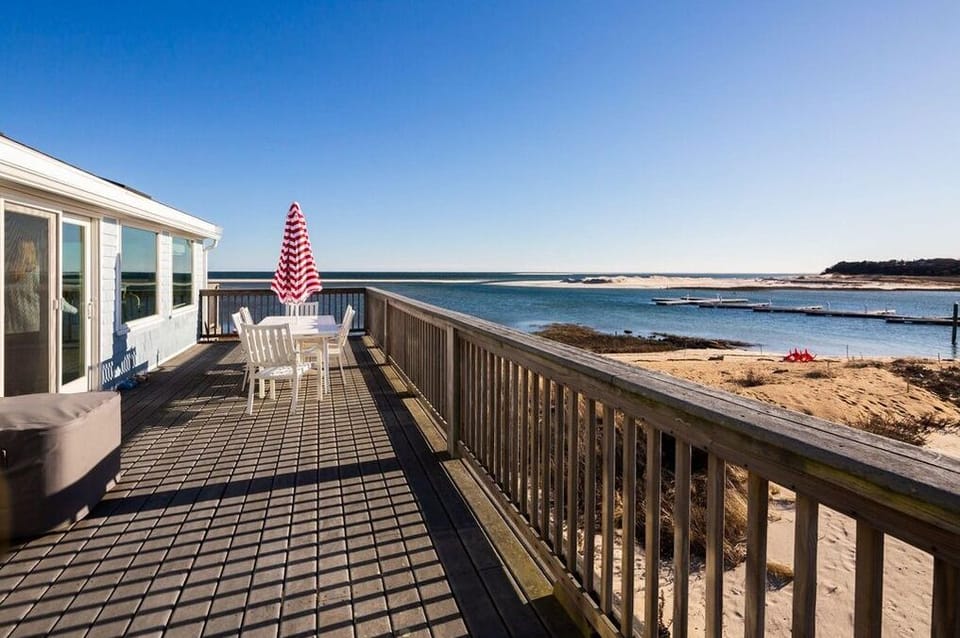 The large deck has a large dining table w/umbrella, adirondacks & agrill 