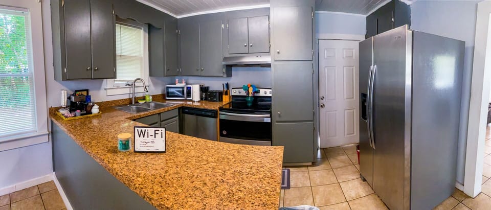 Spacious Kitchen Fully Stocked with Amenities. New Stainless Steel Appliances.