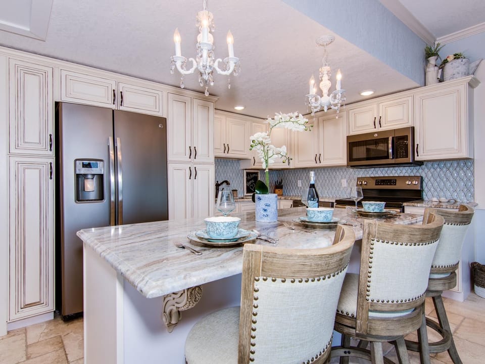 Comfortable bar stools complement marble kitchen island
