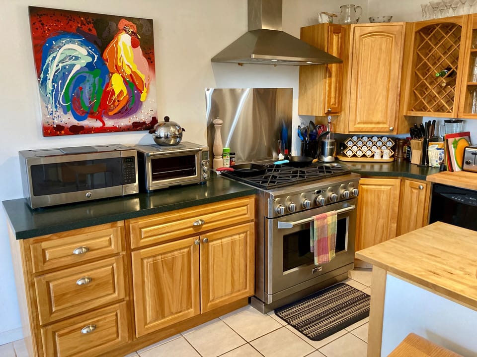 Six burner GE Monogram range, microwave  and toaster oven.