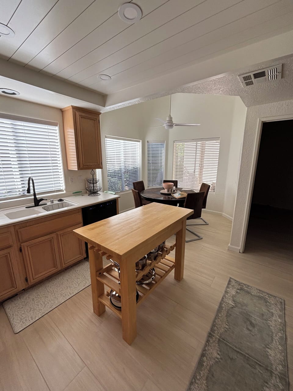 The bright breakfast nook has a beautiful view of the lush, side yard. 