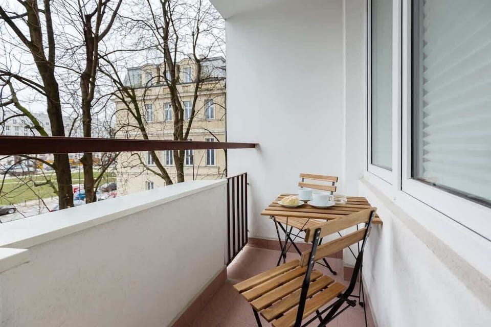 The furnished balcony offers a perfect spot for morning coffee with a view.
