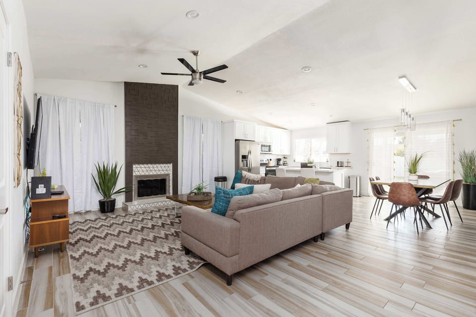 Open living area with a smart TV, cozy furnishings, and a fireplace.