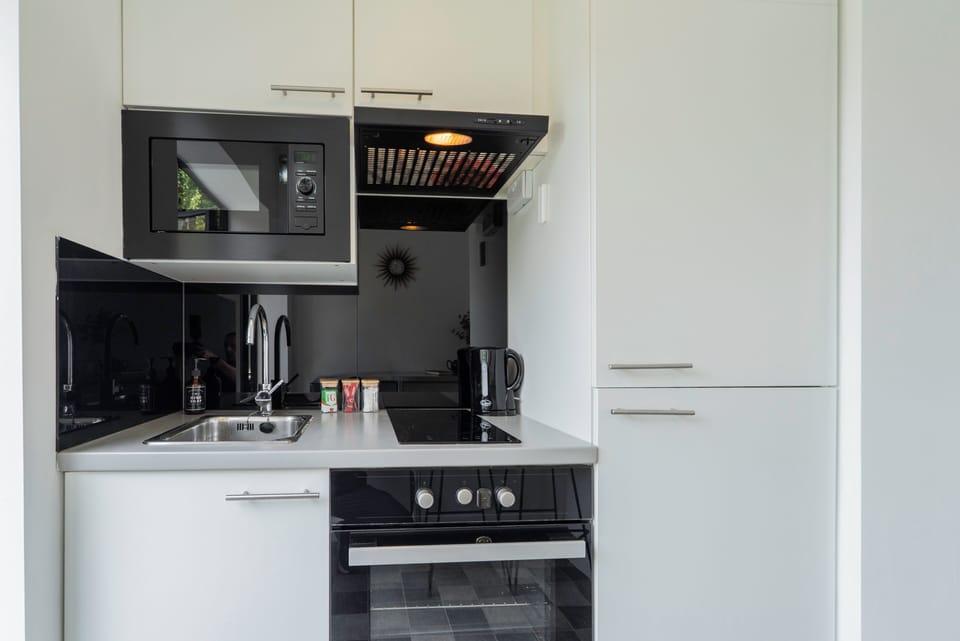 Compact private kitchen with full oven, fridge/freezer, microwave & hob