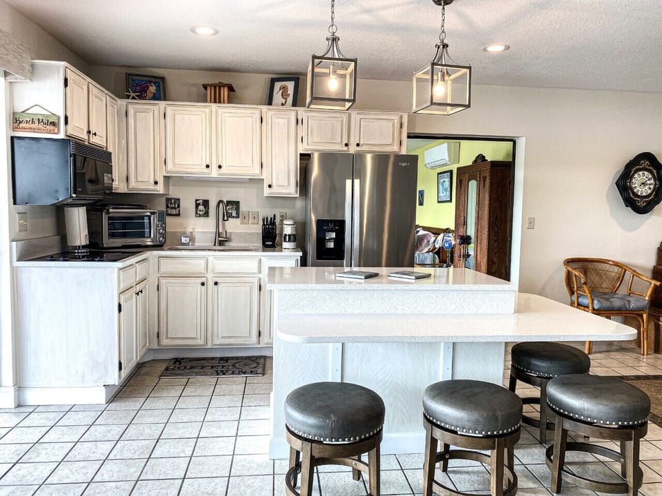 Bright kitchen with white quartz counter tops