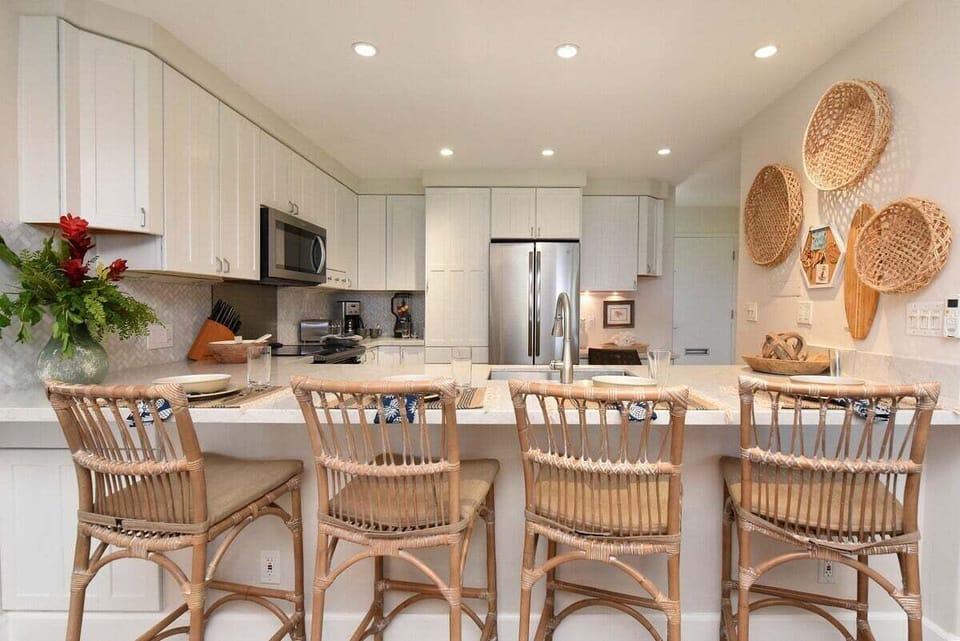 Sleek kitchen countertop with bar seating and stylish pendant lighting, ideal for casual dining or morning coffee.