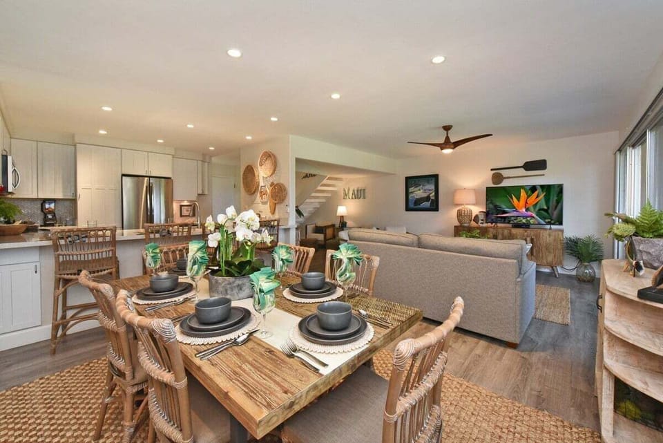 Stylish dining nook featuring modern lighting and tropical accents, creating a warm and inviting atmosphere.