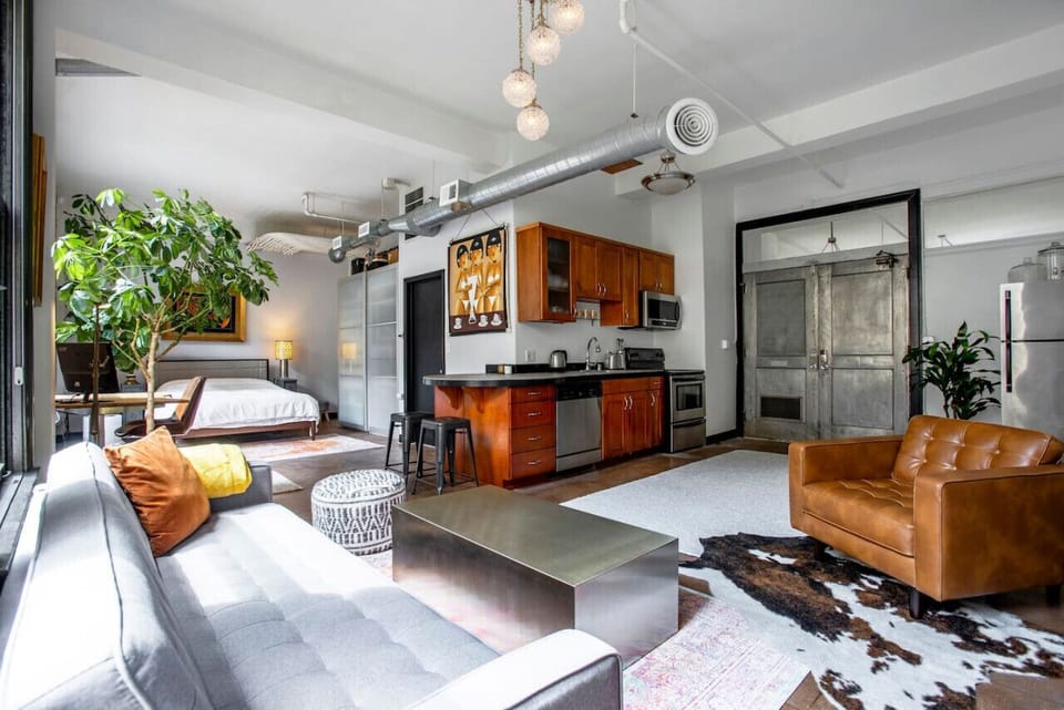 Enjoy a well-lit living area, comfy sofa, and a fully stocked kitchen for a convenient stay.