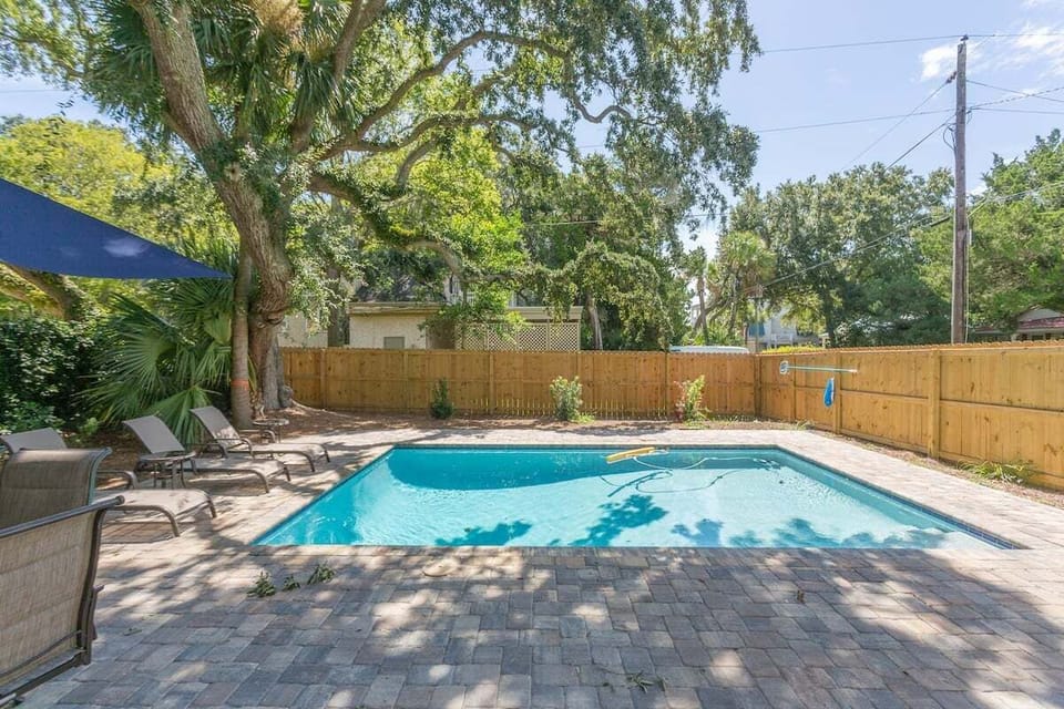 Outdoor pool with surrounding lounge chairs