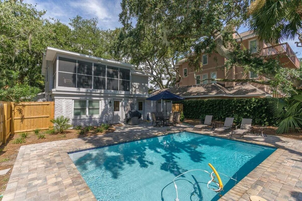 Alternate view of outdoor pool with a view of the property