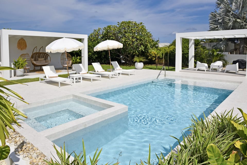 Rear Garden View with Pool and Jacuzzi with Lounge Chairs