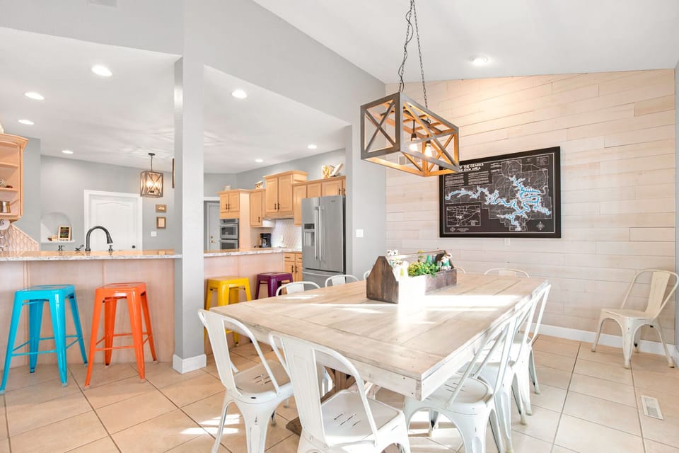 A huge table off of the kitchen and dining room table. Along with 4 barstools for extra seating space.  This of all of the great meas you can have with your group around this table!