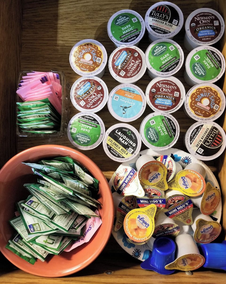 Various Keurig coffee pods, creamers and sugar.