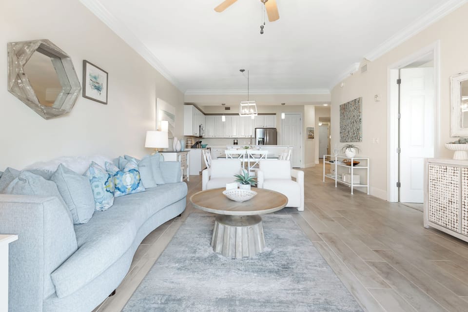 Sink into plush coastal comfort where the living room flows seamlessly into your fully equipped kitchen, creating the perfect space to unwind and gather.