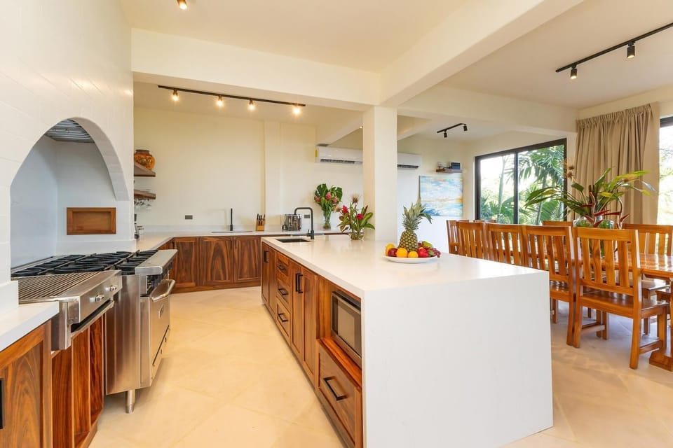 Open kitchen and dining area with large island, perfect for group meals.