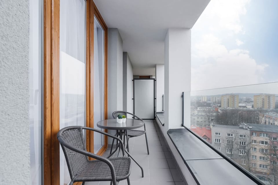 Spacious balcony with outdoor furniture. 