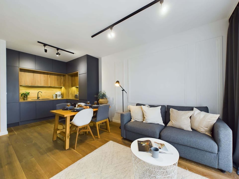 An open-plan living room with a sofa and dining area, enhancing the spacious feel of the room.