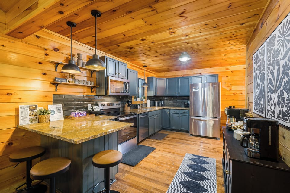 Updated, open-concept kitchen with stainless appliances, tile backsplash, and casual eat-in and bar seating.