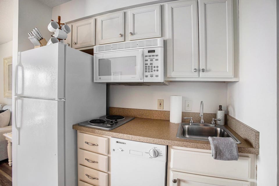 Perfect for prepping light meals or enjoying local takeout. Small appliances include: coffee maker, toaster, electric kettle, cookware, and dishes