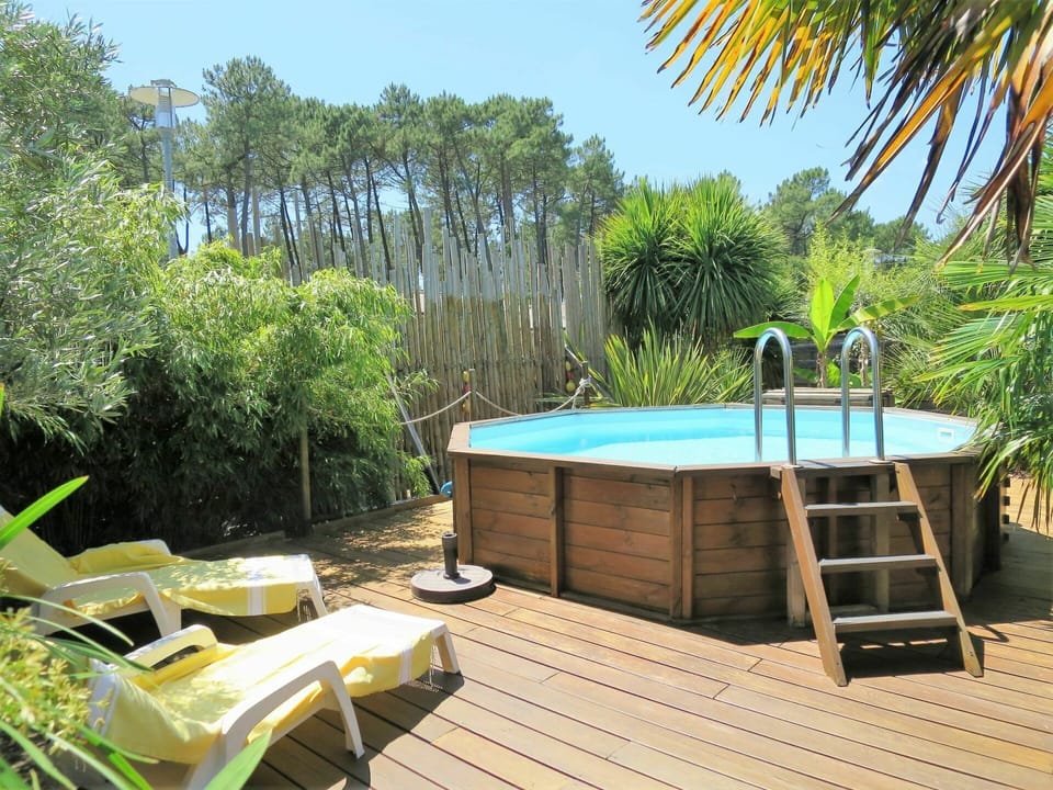Water, Plant, Sky, Plant Community, Furniture, Tree, Outdoor Furniture, Natural Landscape, Swimming Pool, Vegetation
